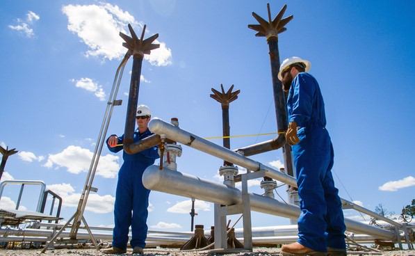 Workers inspecting ground flare system Workers inspecting ground flare system